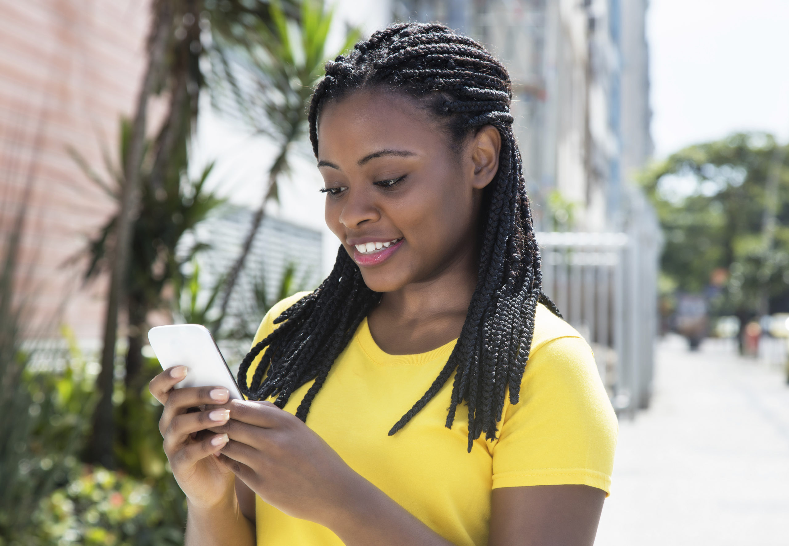 African-american-woman-texting-message-with-mobile-phone-000084696113_Full-scaled.jpg