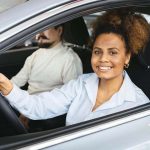 1-The-double-edged-sword-of-insurance-tracking-programs-smiling-woman-in-car.jpg