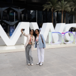 2_Women_standing_infront_of_MWC_Doha_sign_600x400.png