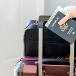 woman-holding-passport-luggage.jpg