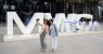 2_Women_standing_infront_of_MWC_Doha_sign_600x400.png