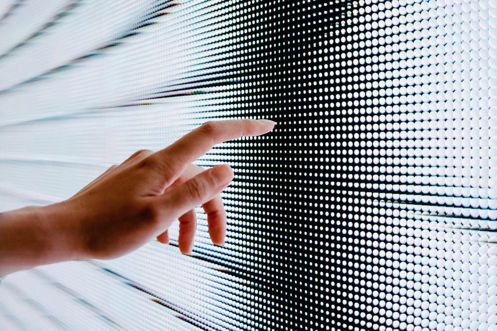 Close-up-of-womans-hand-touching-illuminated-LED-display-screen-connecting-to-the-future-1024x683.jp.jpeg