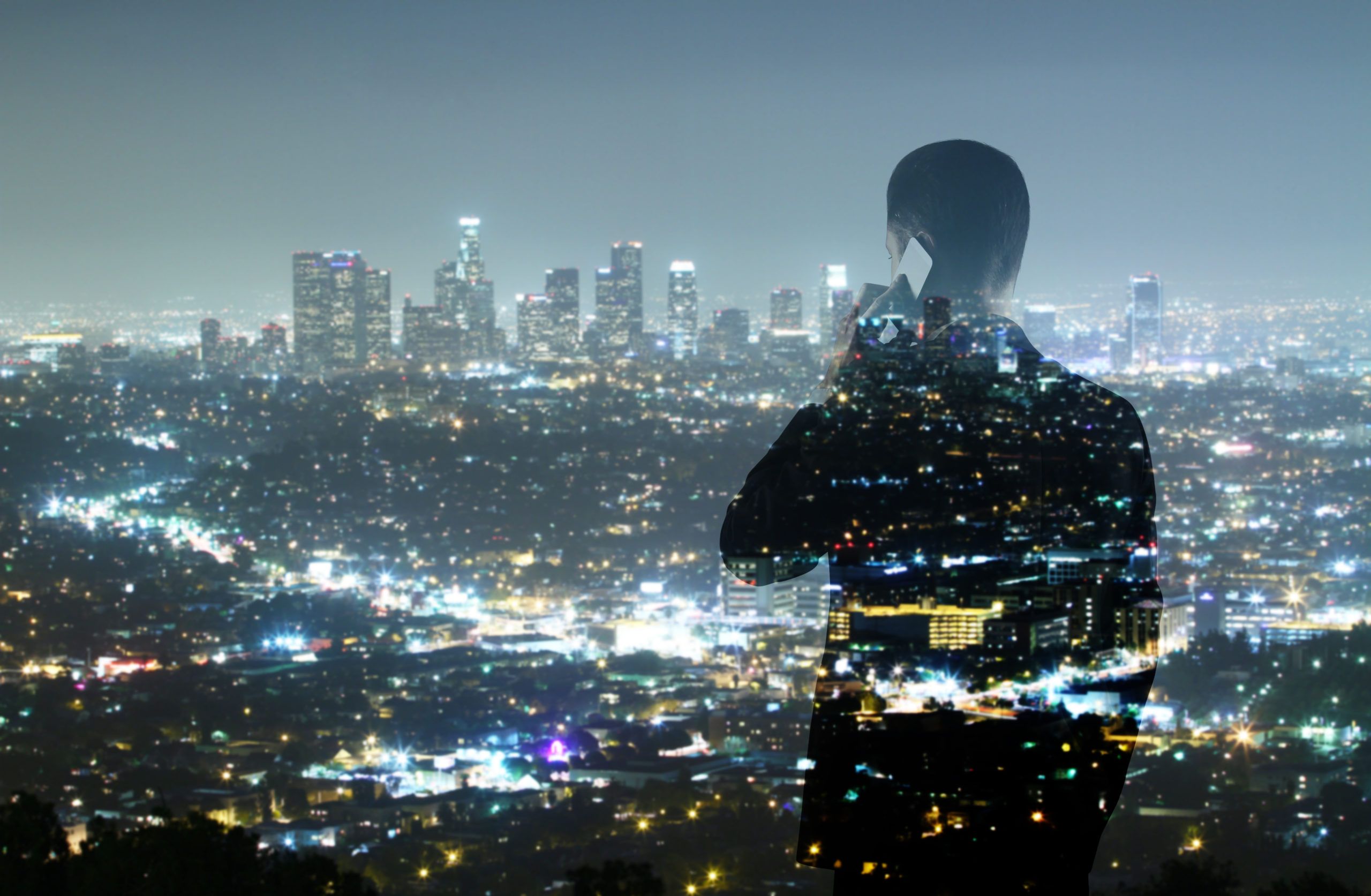 Figure-on-the-phone-infront-of-cityscape-scaled.jpg