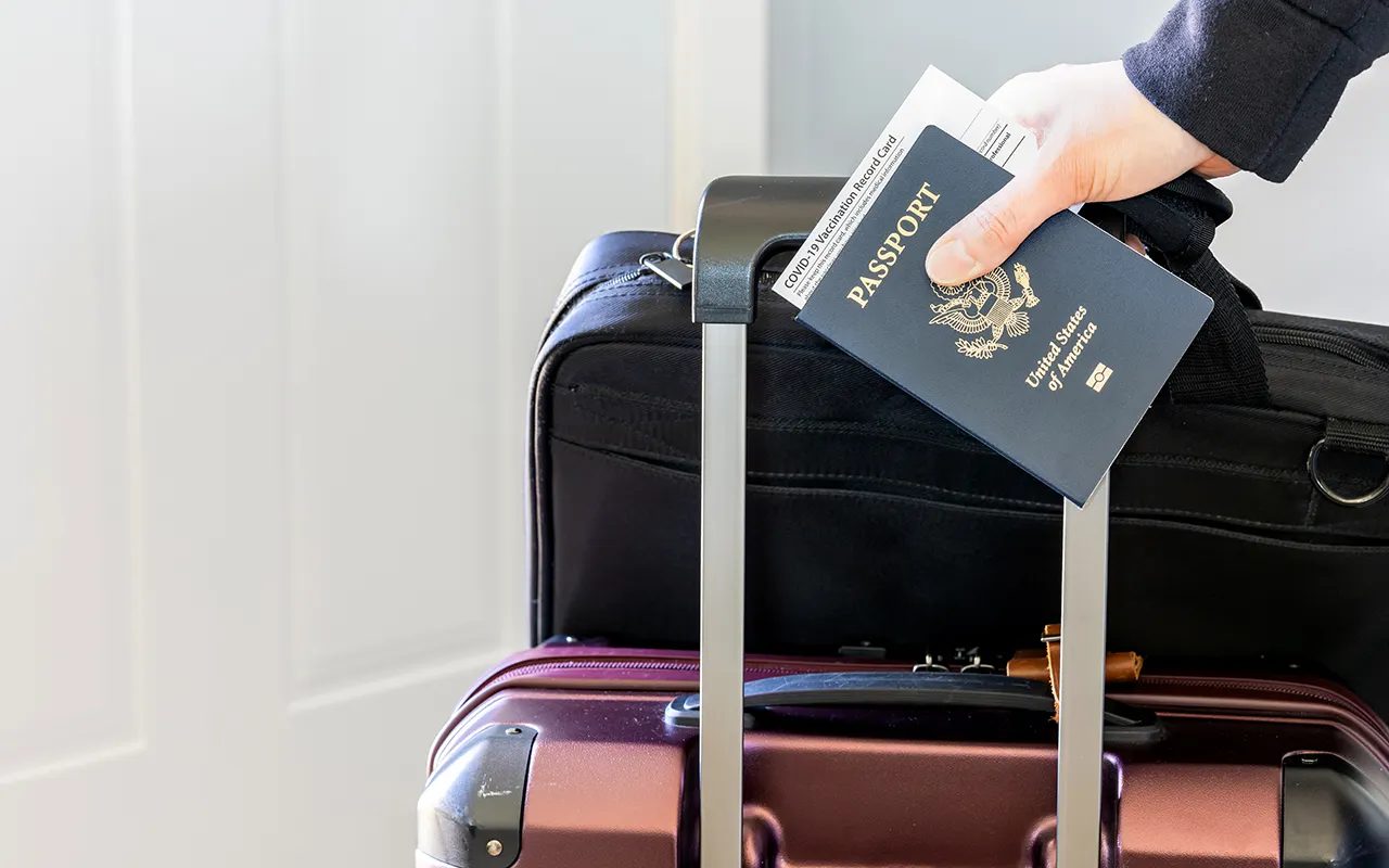 woman-holding-passport-luggage.jpg